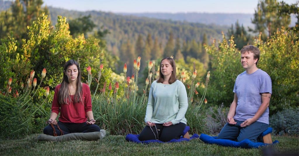 A group meditating outdoors 1200x628 FB 002