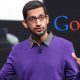 Sundar Pichai, CEO of Google, with the Google logo in the background. The image represents the article's topic, exploring the role of Acting CEO at Google and the future of the company under Pichai's leadership.